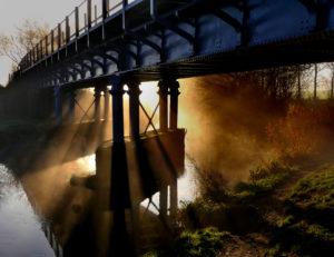Bure Valley railway line over the river bure in the morning